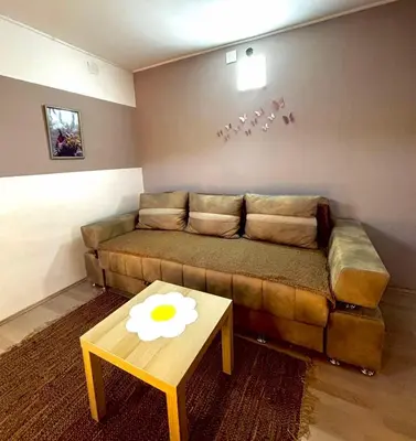 a living room with a couch and a table at Apartmani Radovanovic in Soko Banja