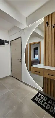 a room with a sliding door and a bedroom at Sanela's Peace in Vrnjačka Banja