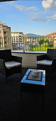 a balcony with two chairs and a table with a view at Sanela's Peace in Vrnjačka Banja