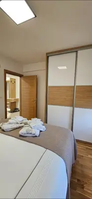 a bedroom with a bed with towels on it at Sanela's Peace in Vrnjačka Banja