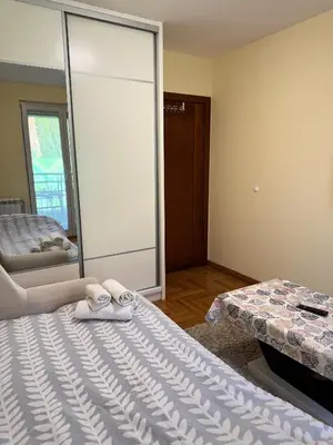 a bedroom with two towels on a bed and a mirror at Vrnjacki kutak in Vrnjačka Banja