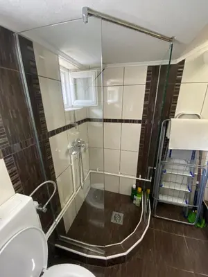 a bathroom with a shower and a toilet at Apartman Porodična priča in Vrnjačka Banja
