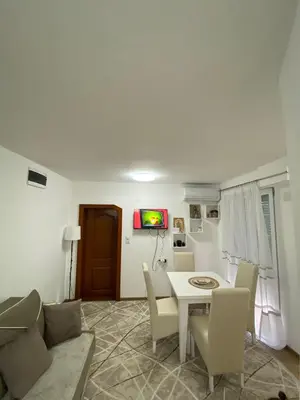 a living room with a white table and chairs at Apartman Porodična priča in Vrnjačka Banja