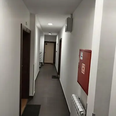 a hallway of an office building with a long corridor at Apartman Iva Brzeće-Kopaonik in Brzeće