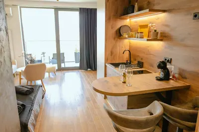 a kitchen with a table and chairs in a room at Luna Residence in Niš
