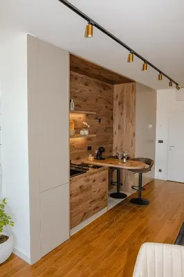a kitchen with wooden walls and a table in a room at Luna Residence in Niš