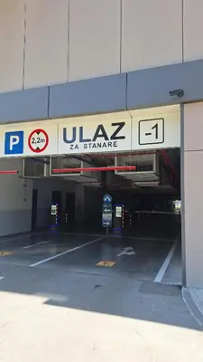 a parking lot with a sign in a parking garage at Luna Residence in Niš