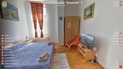 a bedroom with a bed and a chair and a television at Apartmani 