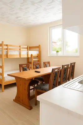 a dining room with a table and chairs and bunk beds at Čardak Zaječar in Zaječar