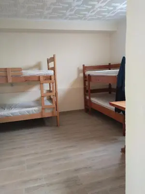 a room with two bunk beds and a wooden floor at Čardak Zaječar in Zaječar
