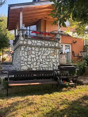 a bench sitting in front of a stone building at Kuća za odmor braća Jevtić Vrnjačka Banja in Vrnjačka Banja