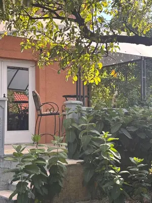 a bench sitting on the porch of a house at Kuća za odmor braća Jevtić Vrnjačka Banja in Vrnjačka Banja