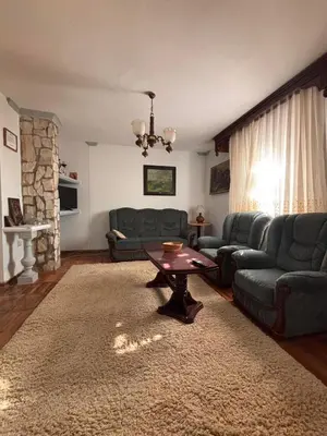 a living room with two couches and a table at Kuća za odmor braća Jevtić Vrnjačka Banja in Vrnjačka Banja