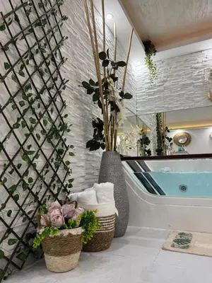 a bathroom with two baskets of towels and a tub at SpaNish apartman 5 in Niš