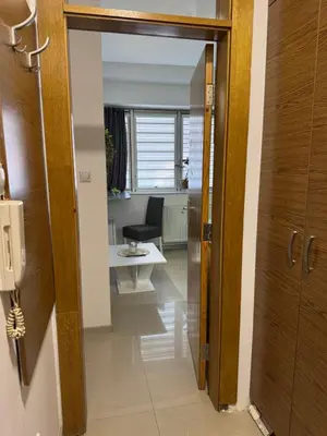 an open door leading into a room with a desk at SpaNish apartman 6 in Niš