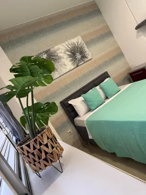 a living room with a bed and a couch at SpaNish apartman 6 in Niš