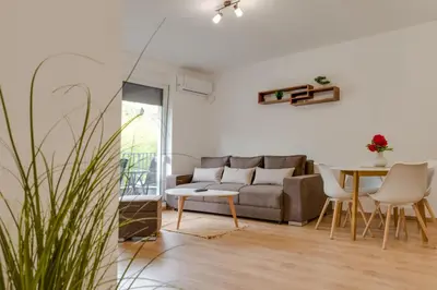 a living room with a couch and a table at Dina LUX apartman in Vrnjačka Banja