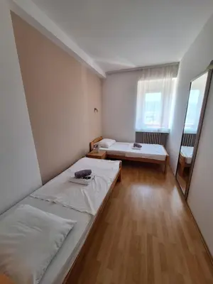 a small room with a bed and a mirror at Hotel Konaciste Trstenik in Trstenik