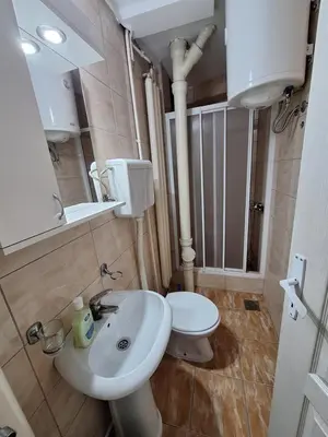 a bathroom with a white sink and a toilet at Hotel Konaciste Trstenik in Trstenik