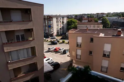 an aerial view of a parking lot between two buildings at Apartman A PLUS in Vranje