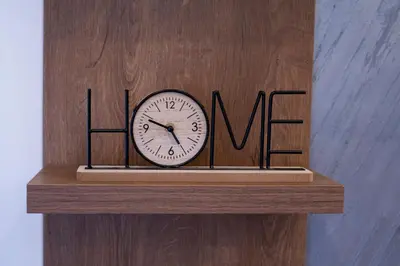 a clock on top of a wooden shelf with the wordulum at Apartman A PLUS in Vranje