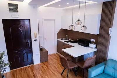 a small kitchen with a table and a counter at Apartman A PLUS in Vranje