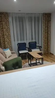a living room with a couch and a table and chairs at Apartmani Katnic in Jagodina