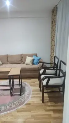a living room with a couch and a table and chairs at Apartmani Katnic in Jagodina