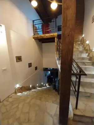 a staircase in a building with a wooden beam at Dvorac Castelo DB 2022 in Vrnjačka Banja