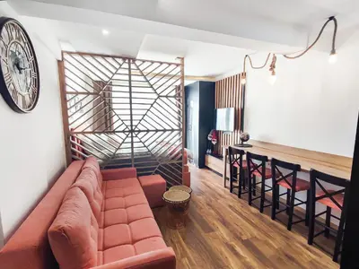 a living room with a couch and a clock on the wall at Kopaonik,President kop app 404 in Kopaonik