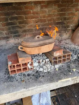 a pot sitting on top of a brick wall with flames at Philippos in Bujanovac