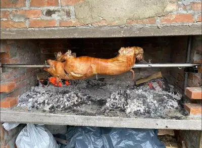 a chicken is cooking in a brick oven at Philippos in Bujanovac