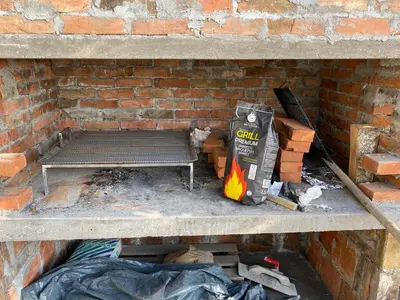 a brick wall with a bench in a brick fireplace at Philippos in Bujanovac