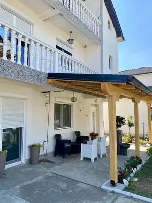 a patio with a blue awning in front of a house at Philippos in Bujanovac