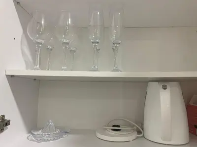 a row of wine glasses sitting on a shelf at LoKA apartman in Paraćin