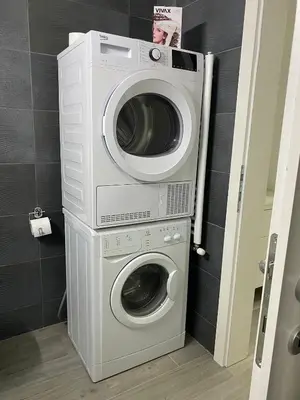 a washer and dryer sitting in a bathroom at LoKA apartman in Paraćin