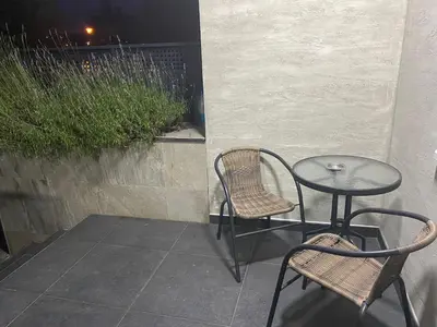 a patio with two chairs and a table and a table and chairs at LoKA apartman in Paraćin