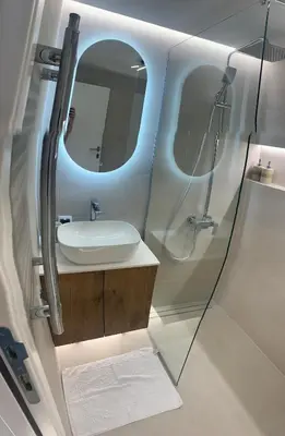 a bathroom with a sink and a mirror at Apartment Jovic in Niš
