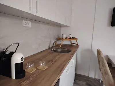 a kitchen with a counter with a sink and aounter at Eva Apartman in Prokuplje