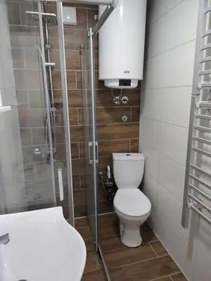 a bathroom with a toilet and a glass shower at Eva Apartman in Prokuplje