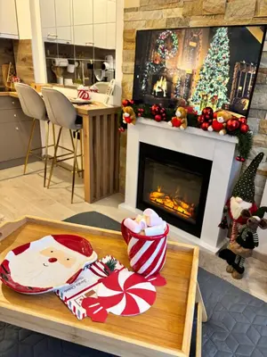 a living room with a christmas tree and a fireplace at Milmari Resort & Spa Kopaonik NLux 72a in Kopaonik