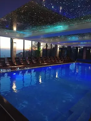 a large swimming pool with chairs in a building at Milmari Resort & Spa Kopaonik NLux 72a in Kopaonik