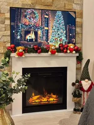 a living room with a fireplace with a christmas tree at Milmari Resort & Spa Kopaonik NLux 72a in Kopaonik