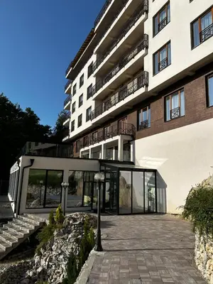 a building with a glass door in front of it at Milmari Resort & Spa Kopaonik NLux 72a in Kopaonik