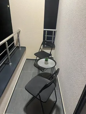 two chairs and a table in a room at Apt1- Sokobanjica apartmani in Soko Banja