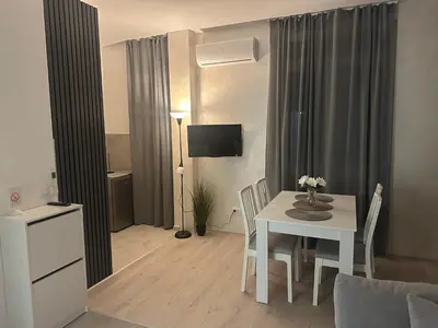 a living room with a white table and chairs at Apt1- Sokobanjica apartmani in Soko Banja