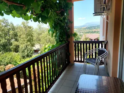 a balcony with a table and chairs and a view at Vila Ramona Sokobanja in Soko Banja