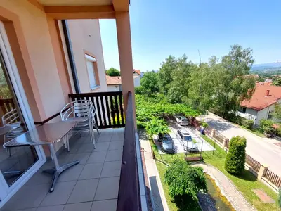 a balcony with a table and a view of a street at Vila Ramona Sokobanja in Soko Banja