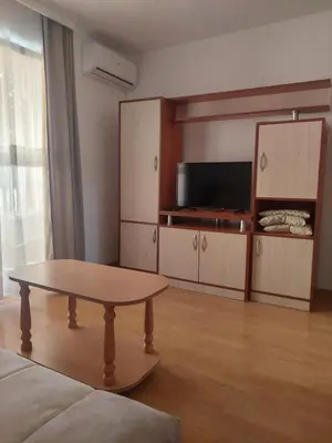 a living room with a table and a tv at Vila Ramona Sokobanja in Soko Banja
