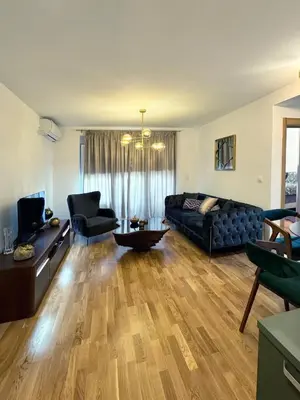 a living room with a black couch and a table at Apartman My Dream in Vrnjačka Banja